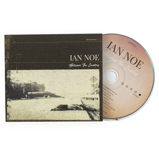 CD and cover of 'Between The Country' by Ian Noe on a white background